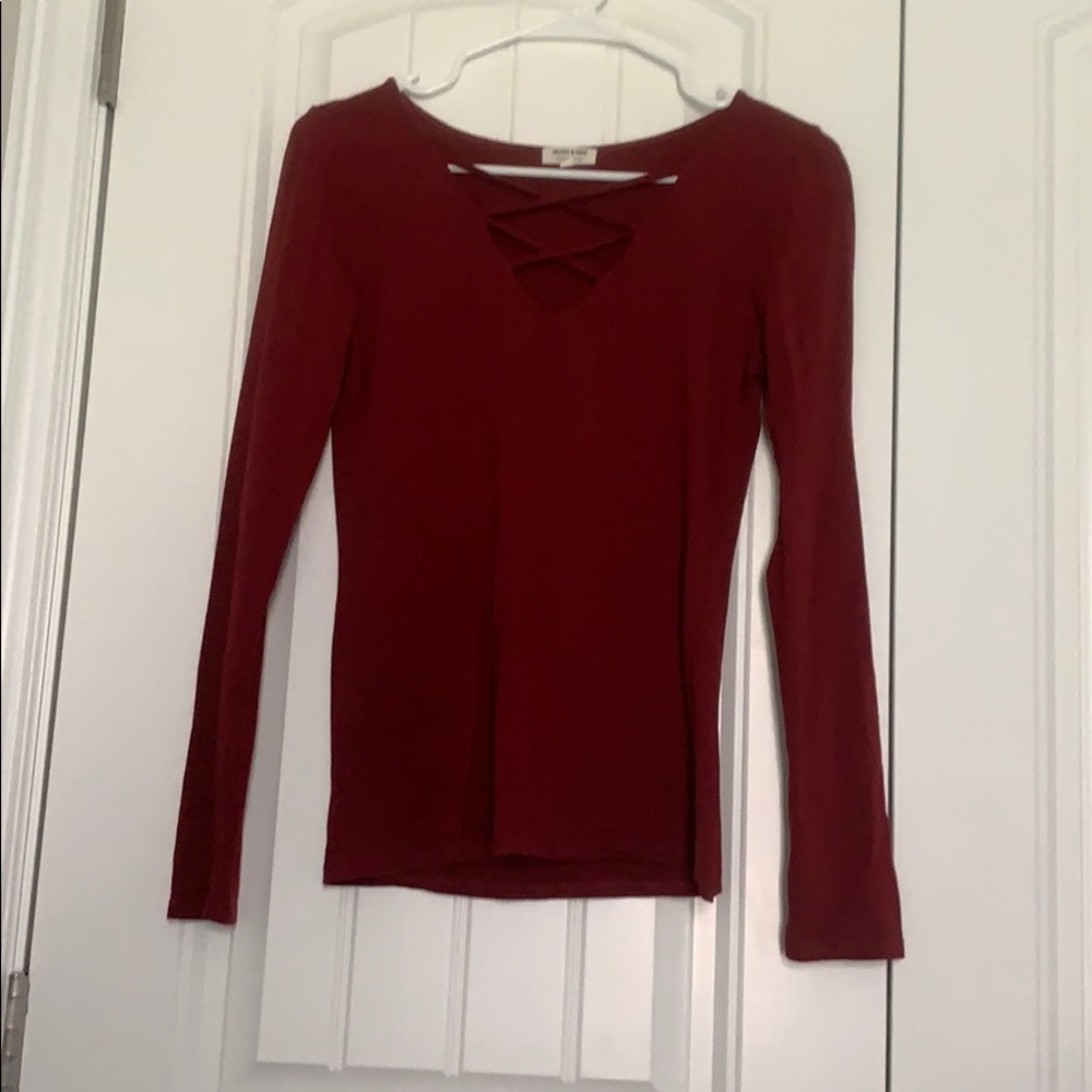 Red long sleeve top with cross straps across chest